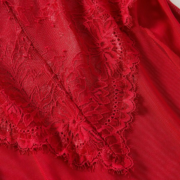 Close-up of red lace trim on sheer mesh cami nightgown with floral detailing and scalloped edges for women’s sleepwear.