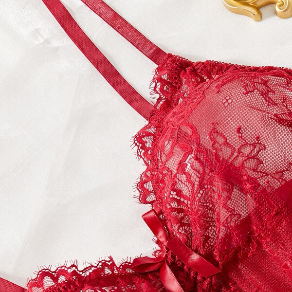 Red lace cami nightgown with adjustable straps, featuring sheer mesh and delicate floral embroidery for a seductive look.
