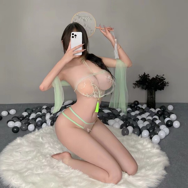 A woman poses on a fluffy rug wearing a lace sheer sleepwear set inspired by hanfu style, featuring a bustier top and matchin...