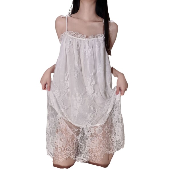 Woman wearing a white lace teddy sleep set with floral patterns, featuring a chemise and garter belt for plus size women.