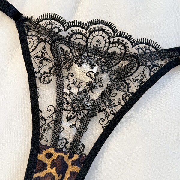 Leopard print lingerie set with sheer mesh bra and panty, featuring intricate black lace detailing for a sensual look.