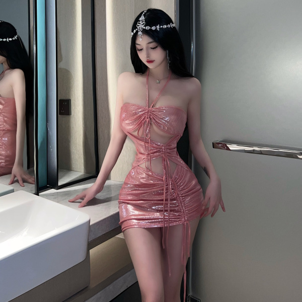 Woman wearing shiny pink liruru pvc lace halter bodycon mini dress with cut-outs, posing in bathroom.
