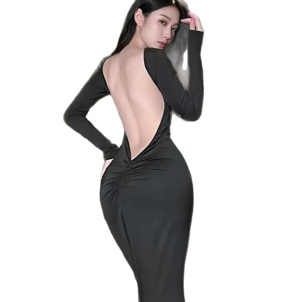 Woman wearing a sleek black backless long dress with ruched detailing, showcasing a seductive and elegant silhouette.
