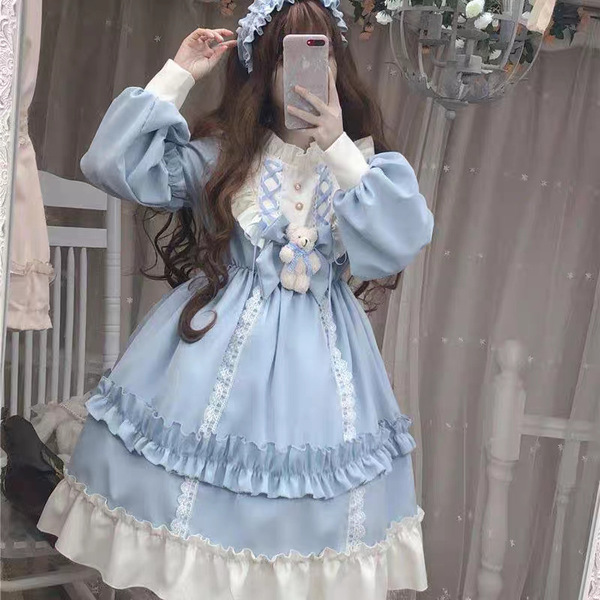 A woman wearing a light blue japanese cosplay maid dress set, featuring long sleeves, ruffled layers, and lace details, perfe...