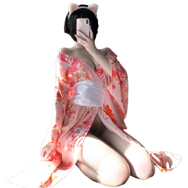 A woman poses with cat ears, wearing a pink floral japanese kimono-style cat lingerie set. the long sheer sleepwear features ...