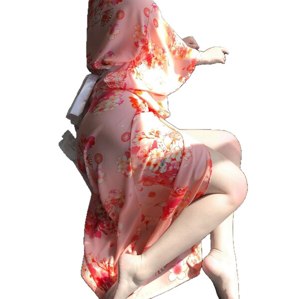 A woman wears a pink floral-patterned japanese kimono-style cat lingerie set, featuring sheer satin fabric, elegant design, a...