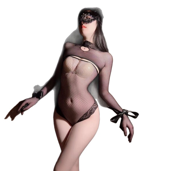 Woman wearing night charm lingerie set - sheer black mesh bodysuit with lace cutouts, long sleeves, and bow details.