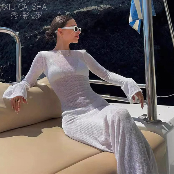 Elegant long-sleeve sheer dress with sexy backless design, perfect for summer vacations. ideal cover-up dress featuring tropi...