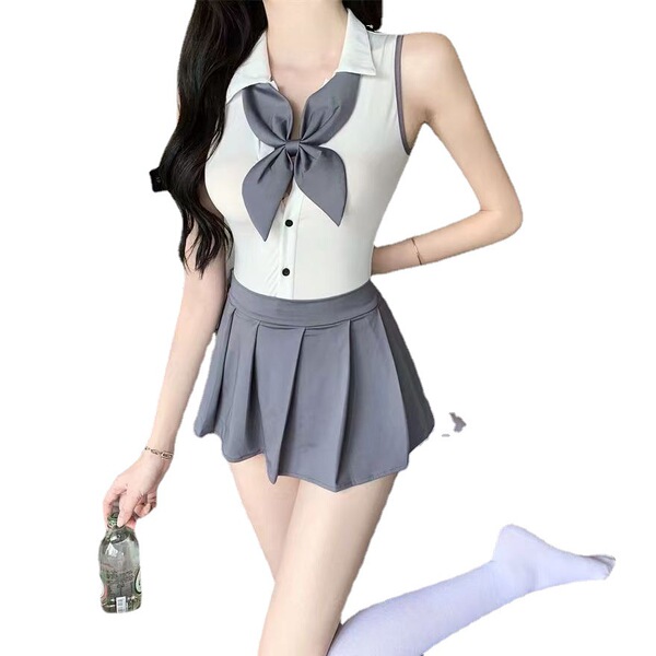 Woman wearing a seductive schoolgirl-style jk uniform set with a white bodysuit, gray bow, pleated skirt, and white stockings...