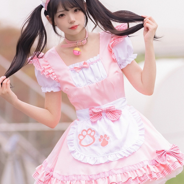 A cute anime girl wearing a maid cosplay dress, featuring a pink apron with paw prints, ruffled sleeves, and a charming colla...