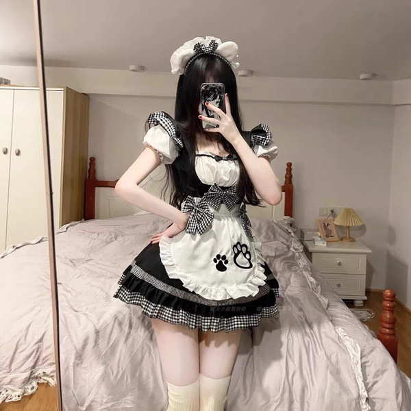 A woman poses in a maid costume cosplay dress, featuring a black and white checkered design with a bow apron and headband. pe...