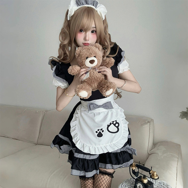 A woman wearing a maid costume cosplay dress, featuring a black and white striped design with a cute apron adorned with paw p...