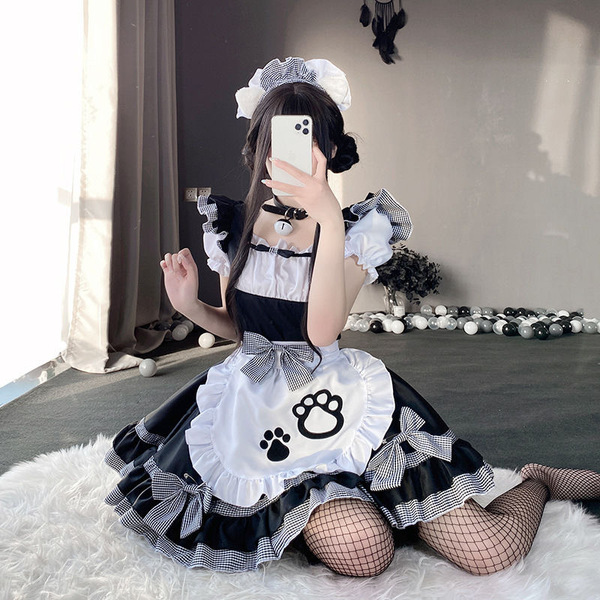 A woman poses in a maid costume cosplay dress, featuring black and white checkered patterns, paws on the apron, and fishnet s...