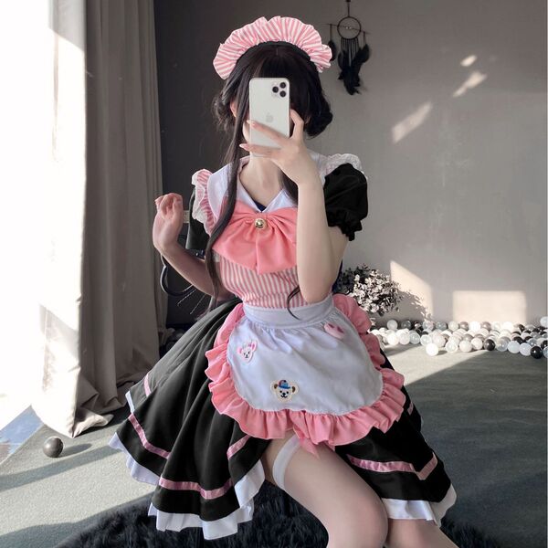 A woman poses in a maid costume cosplay dress, featuring a cute anime cat design, perfect for lolita outfits.