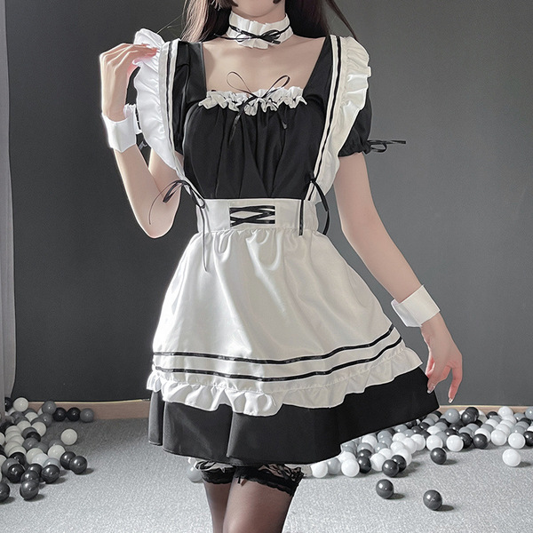 A woman wearing a black and white maid costume cosplay dress, featuring ruffled sleeves, a corset belt, and lace details, per...