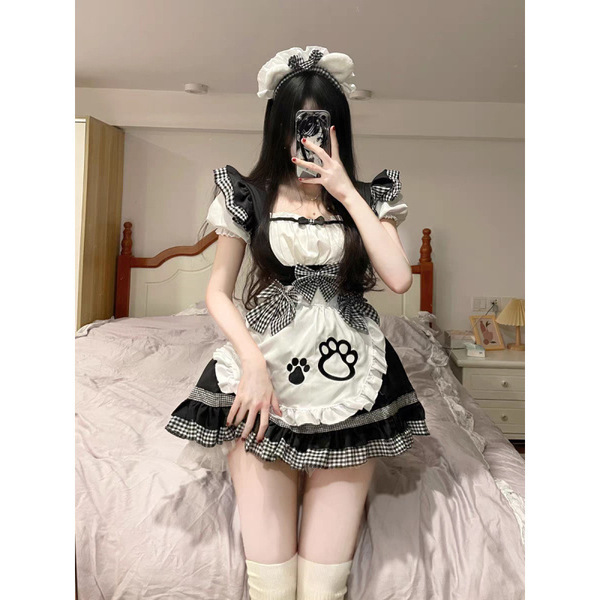 A woman poses in a maid costume cosplay outfit, featuring a cute anime-style dress with cat ears, perfect for lolita fashion....