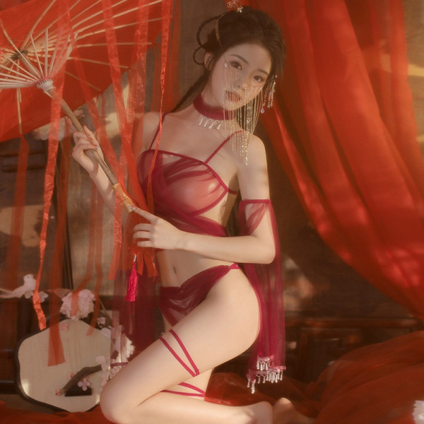 Woman in red sheer lace bralette set with hanfu-inspired design, holding a parasol, surrounded by flowing red fabric.