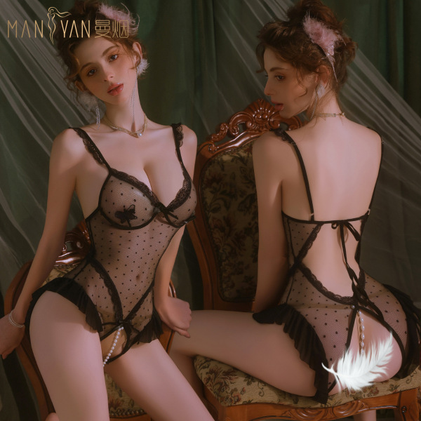 Woman modeling mannyan sheer polka dot lace bodysuit with butterfly details, pearl beading, and open-crotch design.