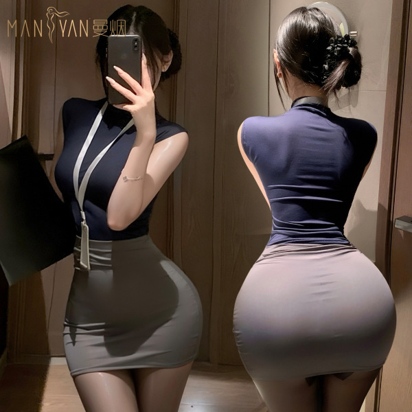Woman modeling mannyan sexy lingerie set – navy top & gray pencil skirt, front and back view in mirror.