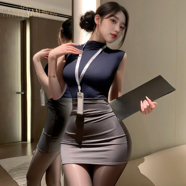 Woman wearing mannyan sexy lingerie set – navy top, gray pencil skirt, sheer tights, holding folder, posing by mirror.