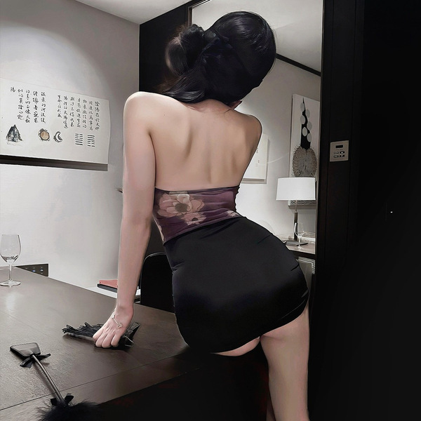 A woman poses in a stylish room, wearing a sheer purple dress with a floral pattern and black stockings. the outfit features ...