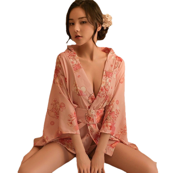 A woman models the mannyqing japanese kimono lingerie set, featuring a deep v-neckline and cherry blossom print on a soft pin...
