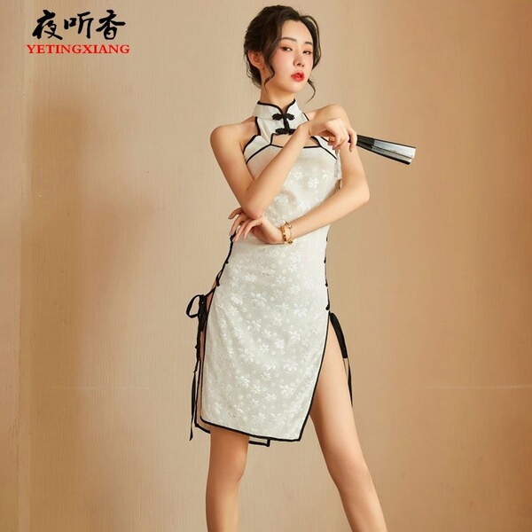 Vintage-inspired cheongsam featuring lace cutouts and ties, elegant design perfect for evening wear.