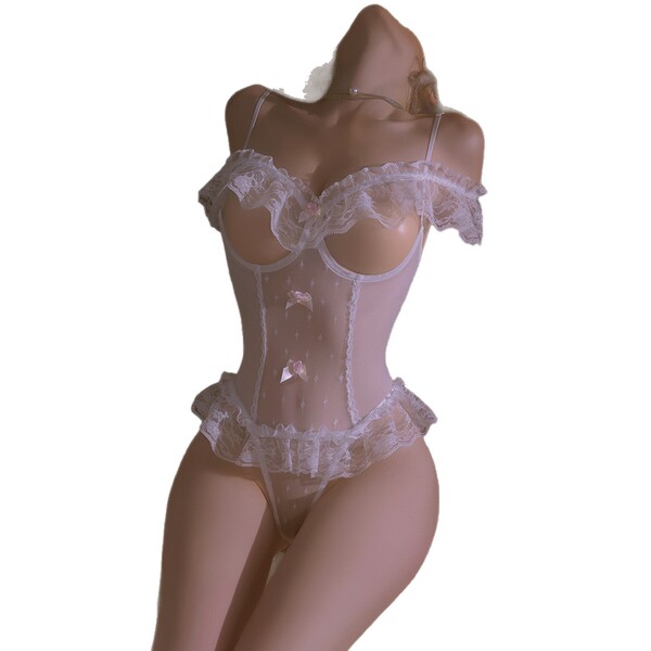 Sheer white lace bodysuit with open-crotch design, ruffled edges, and delicate floral details—perfect for intimate date night...
