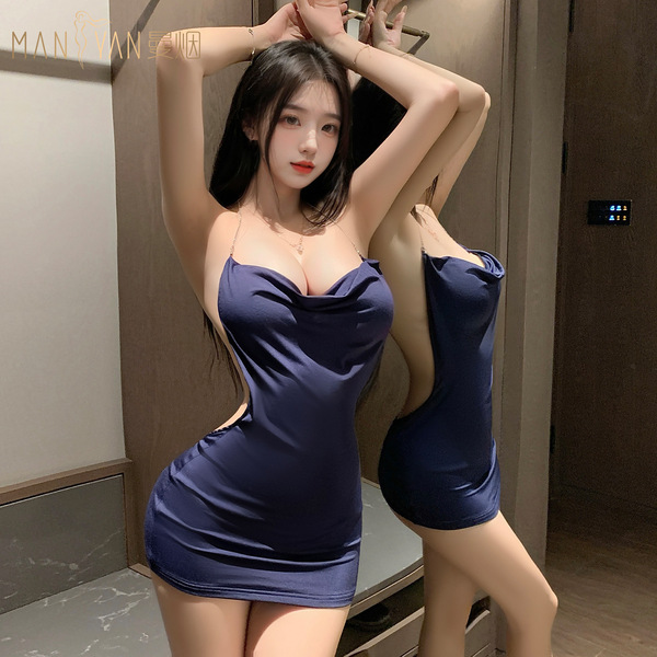 A woman poses confidently wearing a manyan pure & seductive low-cut halter dress, showcasing its bodycon fit and sensual desi...
