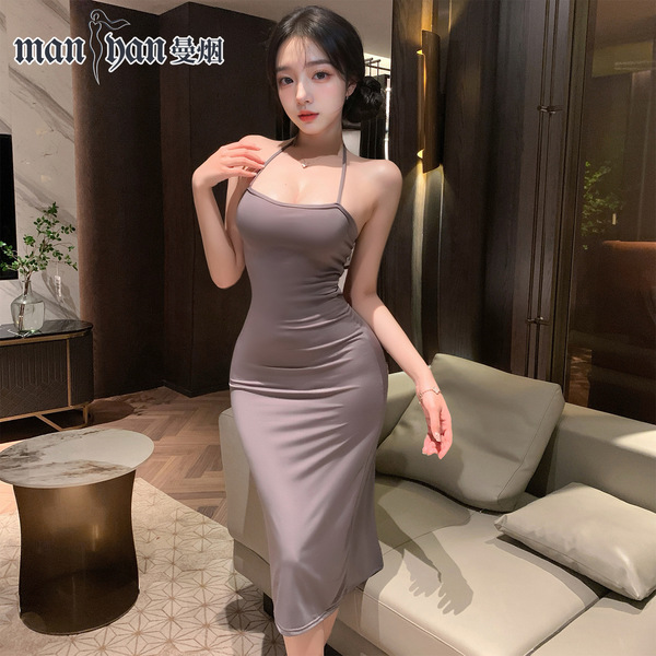 A woman wearing a form-fitting, sleeveless sleep dress with a plunging neckline and lace detailing, highlighting its sexy and...