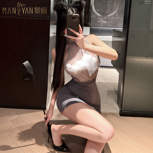 Woman wearing manyan pure & tempting halter neck bodycon skirt set with sheer backless top, posing in mirror selfie.