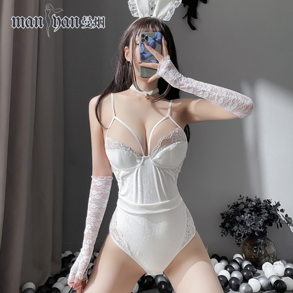Woman wearing white manyan bunny lingerie set with lace gloves, open-crotch bodysuit, and rabbit ears for role play.