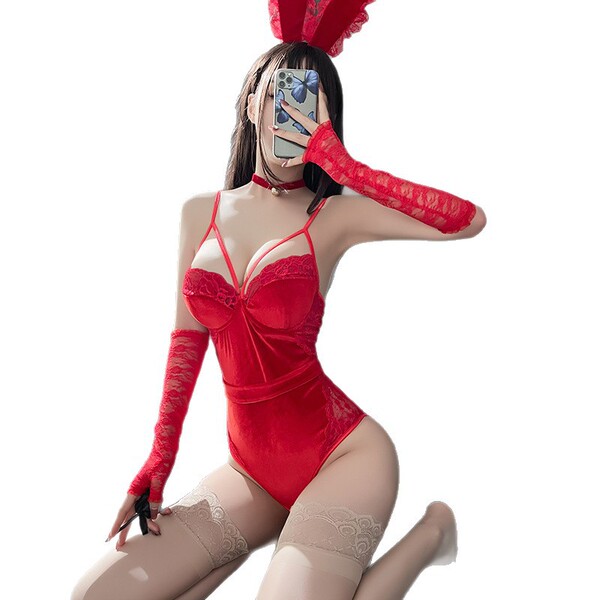 Woman in red velvet bunny lingerie set with lace gloves and ears, posing seductively for role play fantasy.