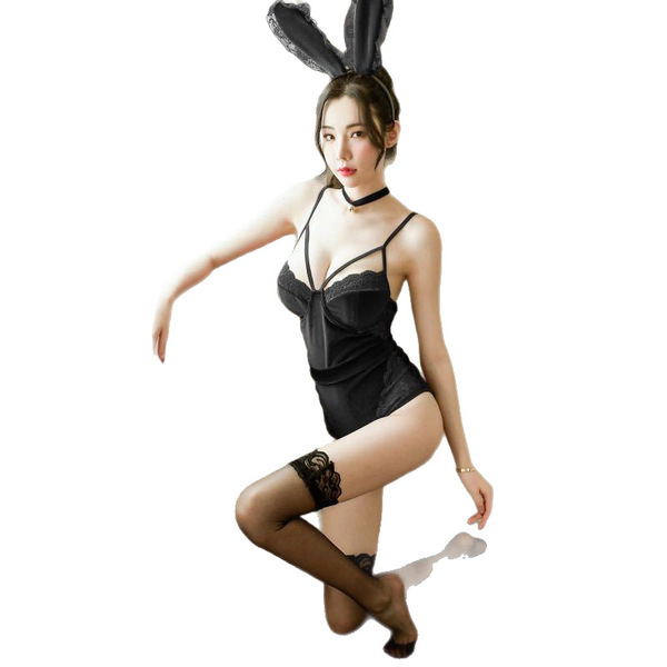 Woman wearing black lace bunny costume with open-crotch bodysuit, rabbit ears, and thigh-high stockings.
