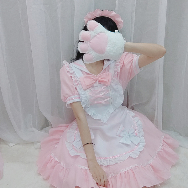 A woman models the miracle nikki cosplay maid dress, featuring a sweet lolita style with pink ruffles, bows, and a frilly apr...