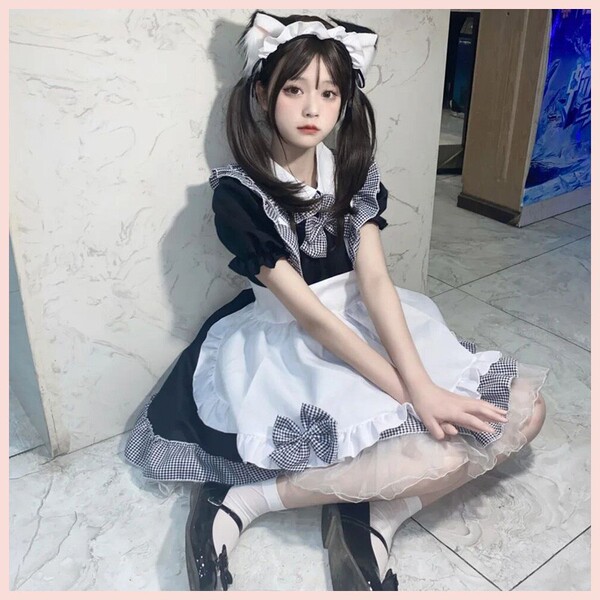 A girl wearing a black and white maid costume dress, featuring ruffles and bows, perfect for lolita cosplay or crossplay enth...