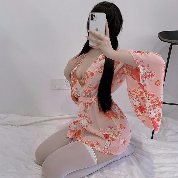 A woman poses with a smartphone, wearing a pink misty romance kimono lingerie set featuring cute cat designs. the outfit incl...