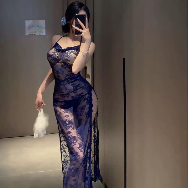 Woman in navy lace cami set with high slit, holding feather accessory; modest yet alluring sleepwear by naben.