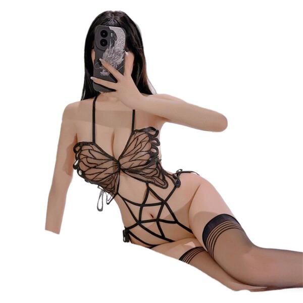 Woman wearing black butterfly-themed open-crotch bodysuit with adjustable ties, part of the night desire plus size sensual li...