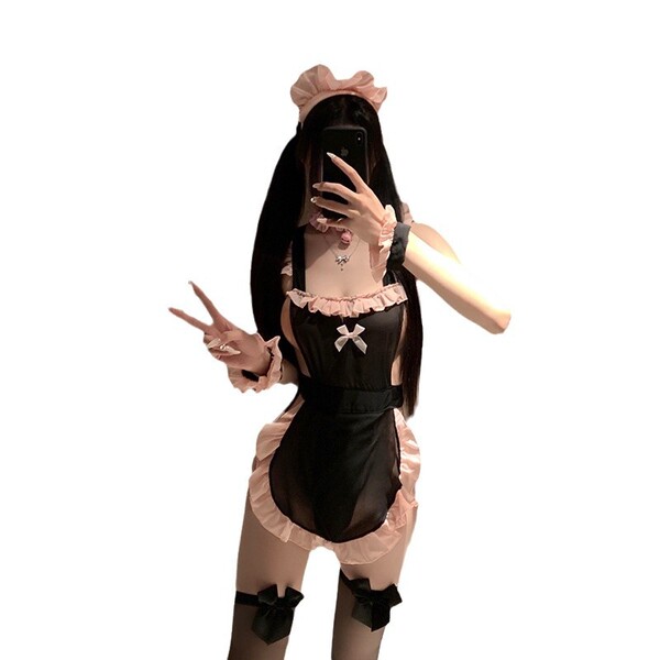 A person wearing a black and pink maid costume, featuring frills and bows, poses playfully while holding a phone. the outfit ...
