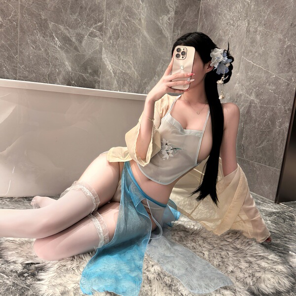 A woman poses in a bathroom, wearing a night silk hanfu lingerie set featuring a seductive cross-slit bodice and halter neck ...
