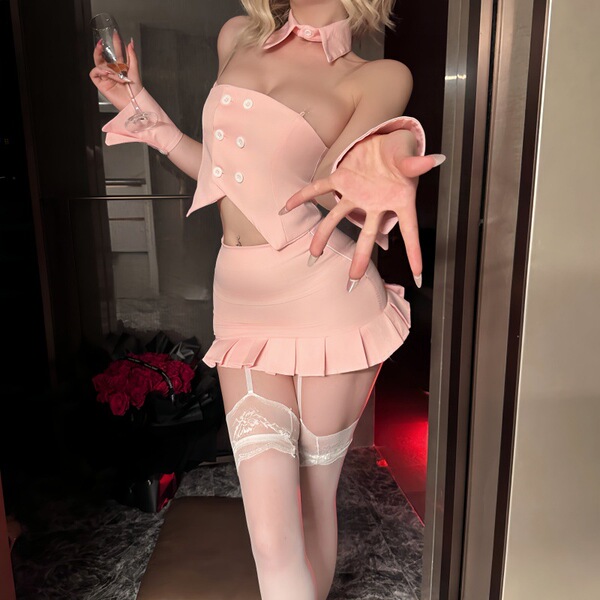Woman wearing pink night-silk sensual bunny girl lingerie set with ruffled skirt, gloves, and thigh-high stockings.
