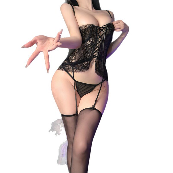 Woman modeling black lace bodysuit with sheer panels and cross-back straps, part of the night silk sensual lingerie set.