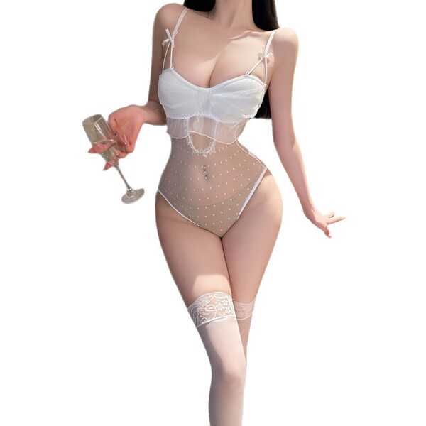Woman in white night silk sexy lace bodysuit with sheer mesh and open-crotch design, holding a wine glass.