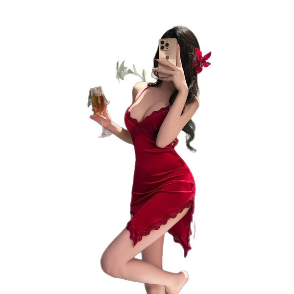 A woman poses elegantly in a red velvet deep v neckline nightgown with lace detailing and a cross-back design, holding a glas...