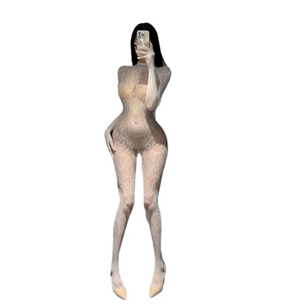 Woman taking selfie in sheer lacy nightsigh bodysuit with high neck and backless design.