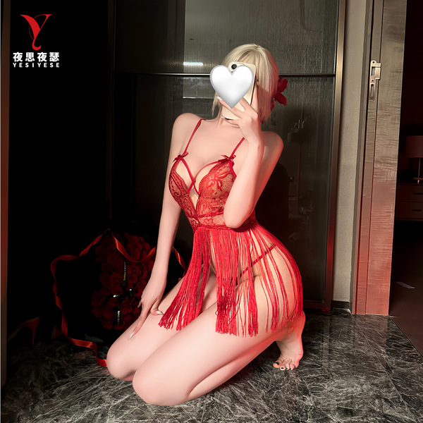Woman kneeling in red lace tie-up sleep dress with deep v and tassels, part of nightsigh nightseduction sexy lingerie collect...