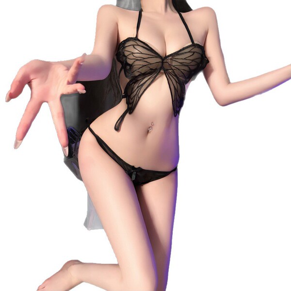 Woman wearing black butterfly lingerie set with tie-dye belly top and matching bottoms, flirty uniform style.