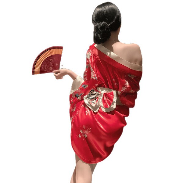 A woman wears a vibrant red japanese geisha sleepwear set, featuring a traditional kimono robe with floral patterns and a dec...