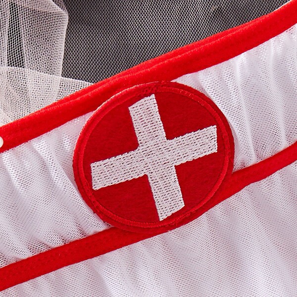 Close-up of red cross emblem on white mesh nurse costume lingerie set with lace trim and open design for role play.